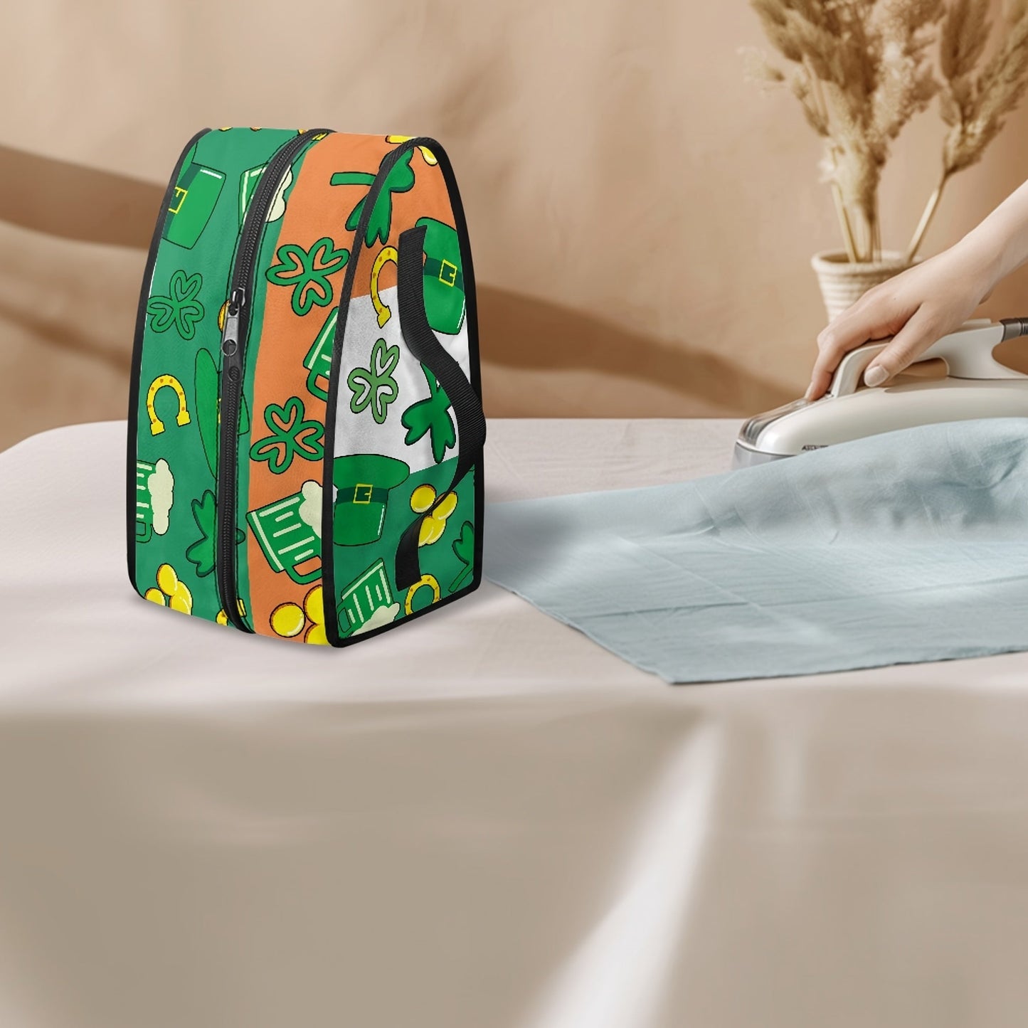 Portable ironing bag with St. Patrick's Day cloverleaf design, perfect for travel or storage. Features top handle and double zipper for easy access. Made of polyester material, dust proof. Ideal holiday gift for anyone in need of a stylish accessory.