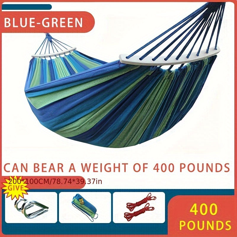 Heavy-duty rainbow canvas hammock for single or double with curved wooden sticks and a weight capacity of 226.8 KG. Includes tree straps for camping, backyard, or patio. High-strength