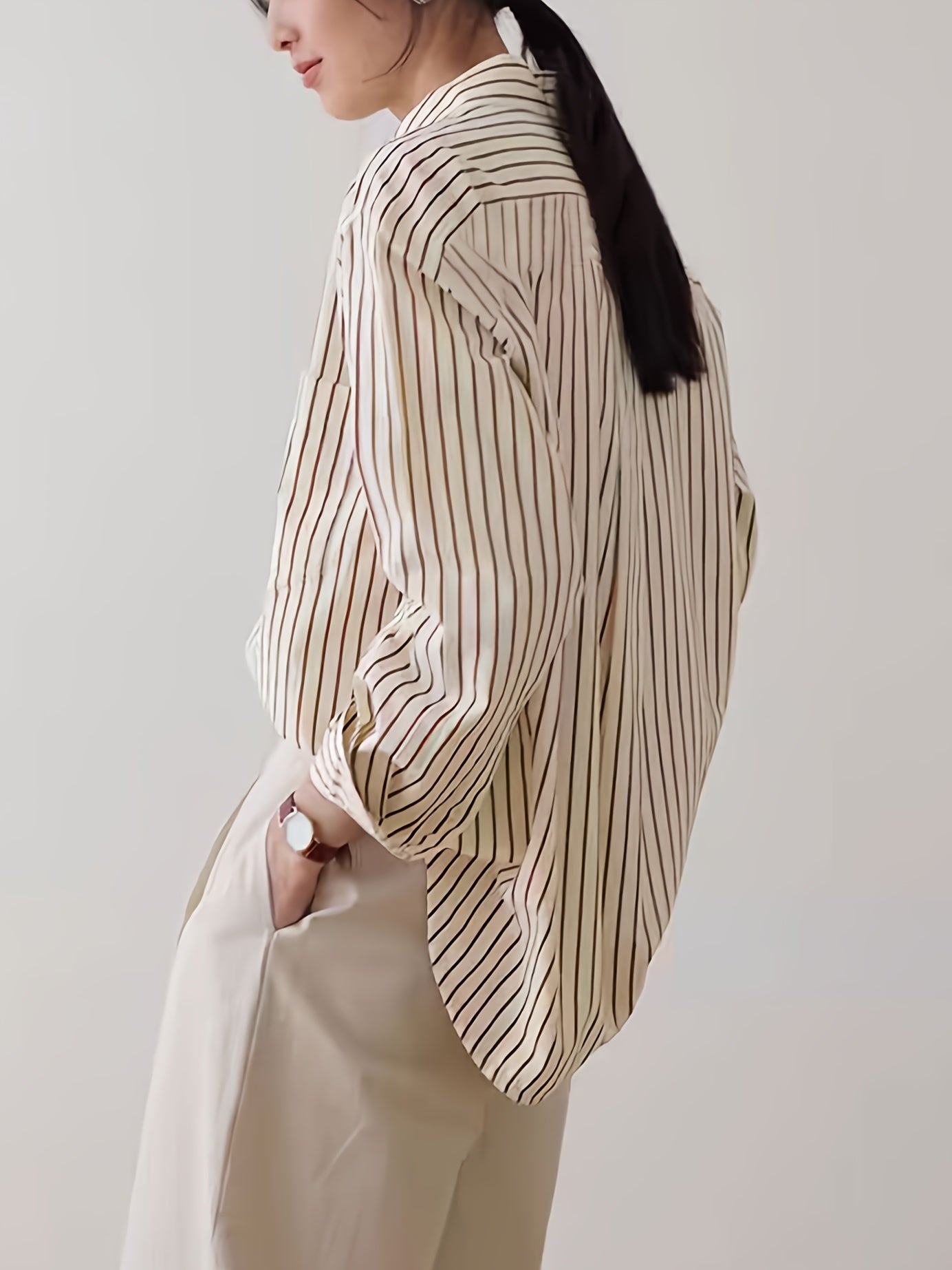 Beige striped blouse with button-up front, loose fit, machine washable.