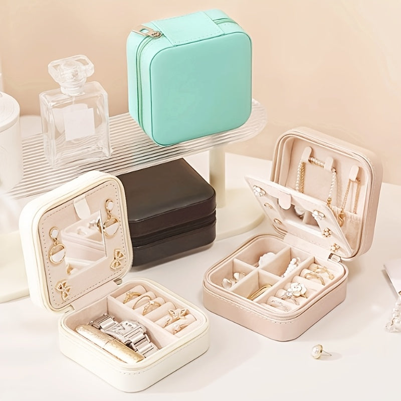 Compact and stylish portable jewelry box with mirror, zipper, and flip cover. Ideal for storing rings, earrings, and necklaces on-the-go.