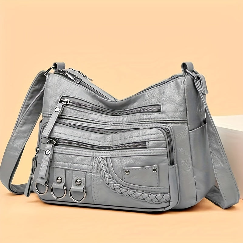 Casual black crossbody bag with multiple zippers for daily use.