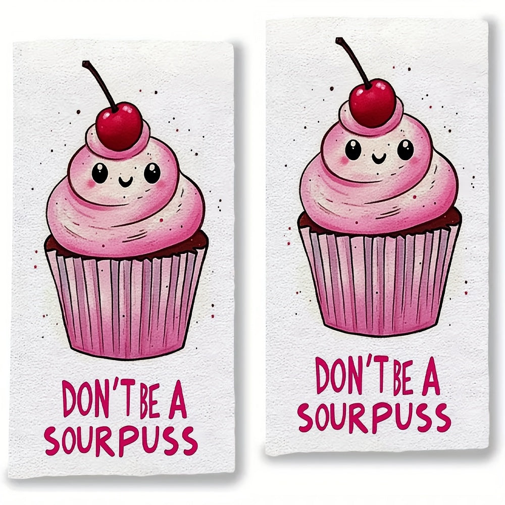 2 pieces of ultra soft kitchen towels featuring a "Don't Be A Sourpuss" cupcake design. These highly absorbent and machine washable dish hand towels have a contemporary style with pink and white stripes. Measuring 40.64x60.96 cm, they are perfect for