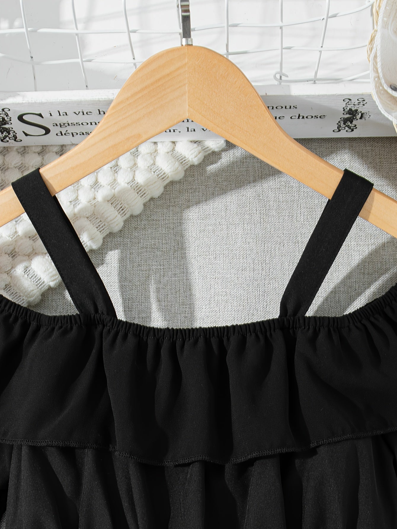 Black chiffon dress with off-shoulder ruffle detail, perfect for casual summer style.