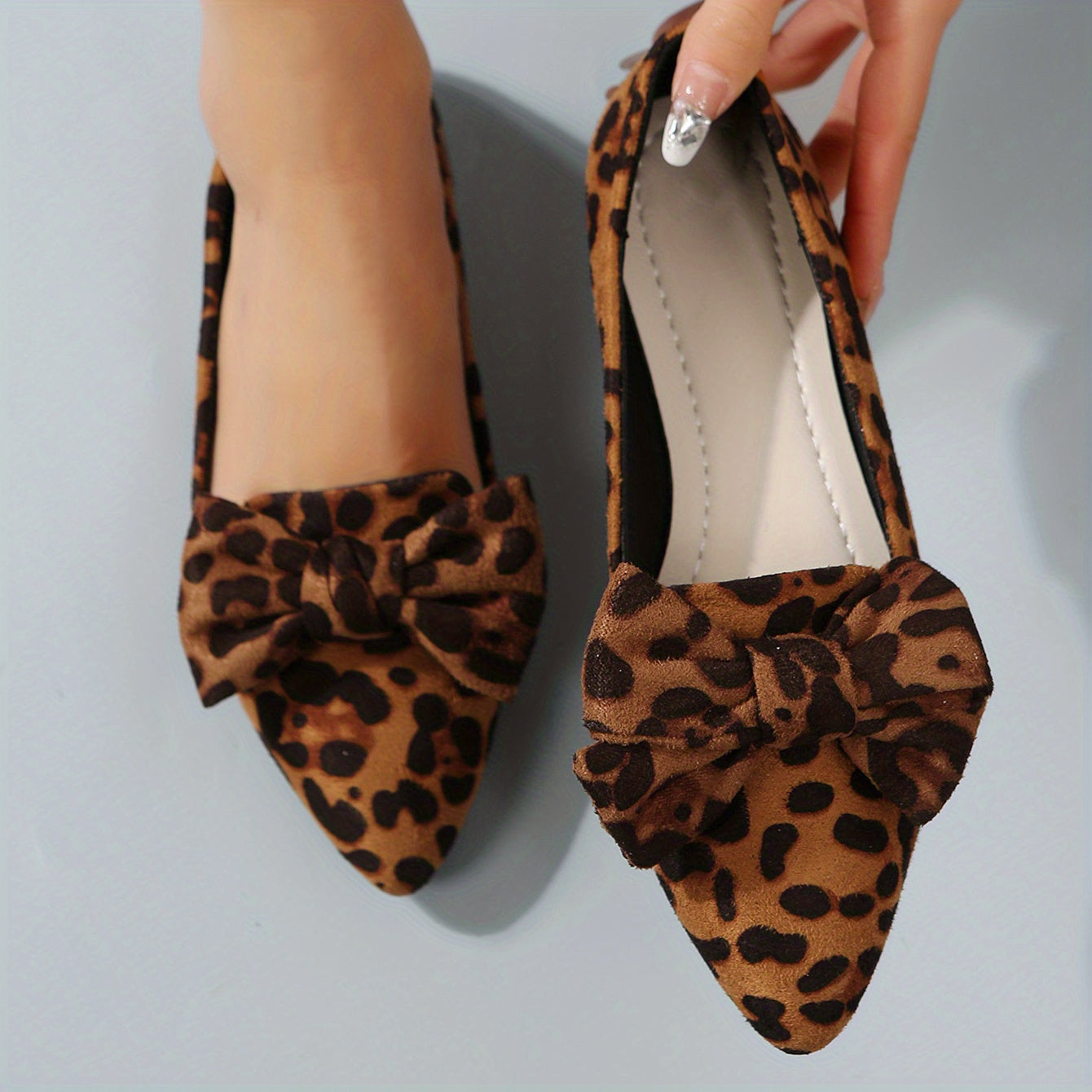 Leopard print flat shoes with bowknot decor and point toe, lightweight slip on style.