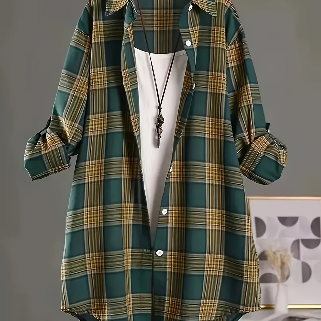 Plus size plaid shirt for women with lapel collar, long sleeves, and dipped hem. Made from 100% polyester with non-stretch woven fabric. Suitable for casual weekend wear in spring.