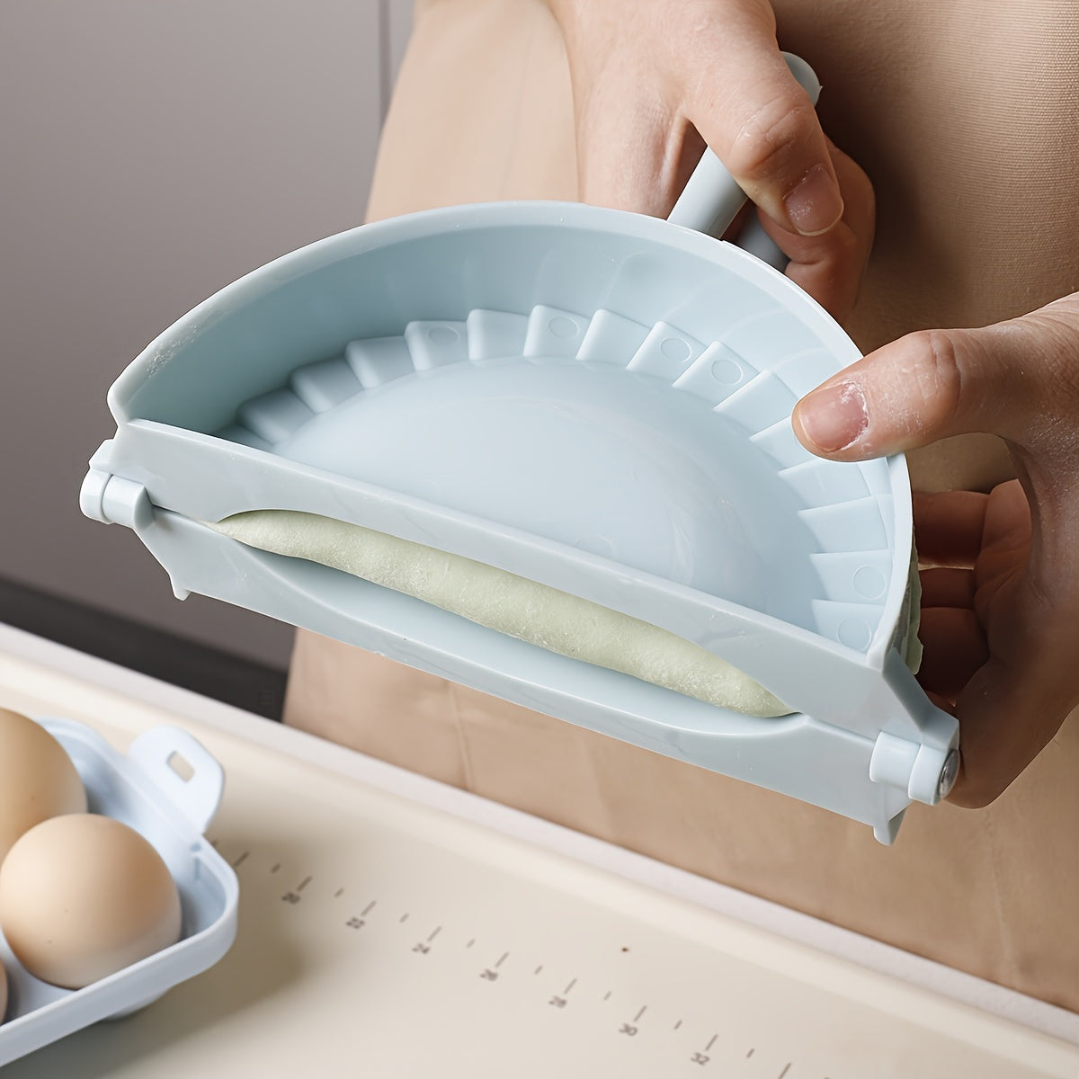 One piece of a plastic dumpling maker, also known as a dumpling mold or manual dumpling wrapper. This versatile kitchen gadget can also be used as an empanada maker and comes with kitchen accessories.