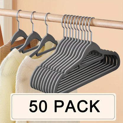 Upgrade your wardrobe organization with this set of 50 sleek black velvet hangers. These non-slip hangers feature 360° swivel hooks and a slim design, perfect for suits, coats, dresses, and more. Made from durable ABS plastic, these hangers are ideal for