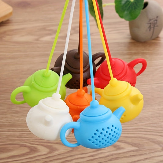 Creative teapot-shaped silicone tea infuser with handle, perfect for steeping loose tea leaves or flavoring tea with spices. A versatile kitchen gadget for tea enthusiasts.