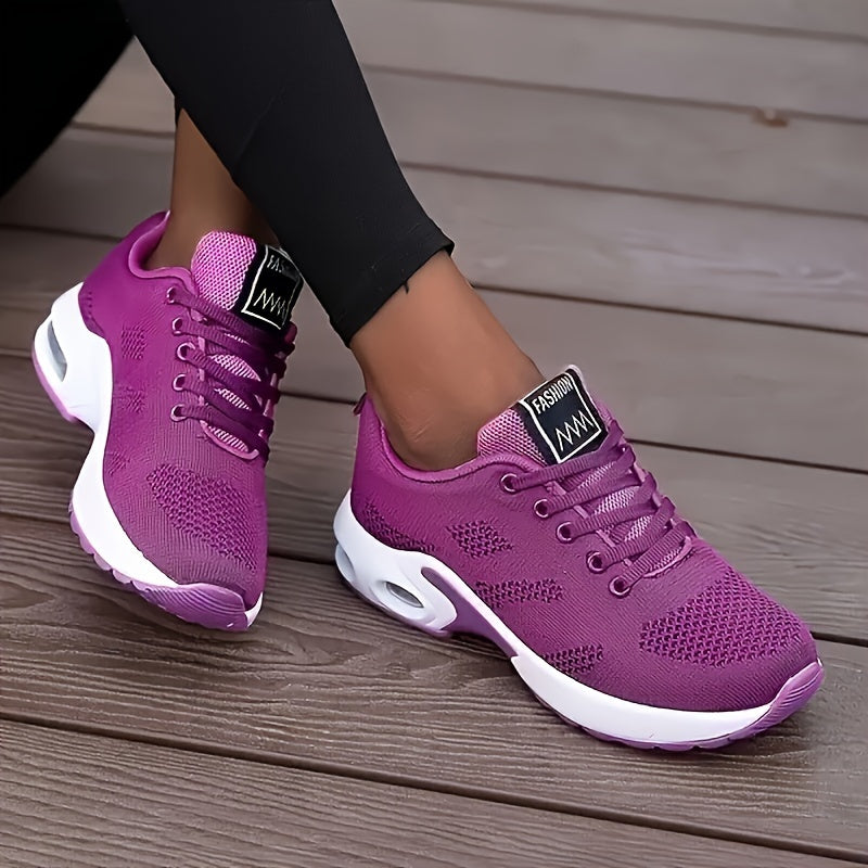 White running shoes for women with breathable knit material, air cushion sole, and shock-absorbing platform design.