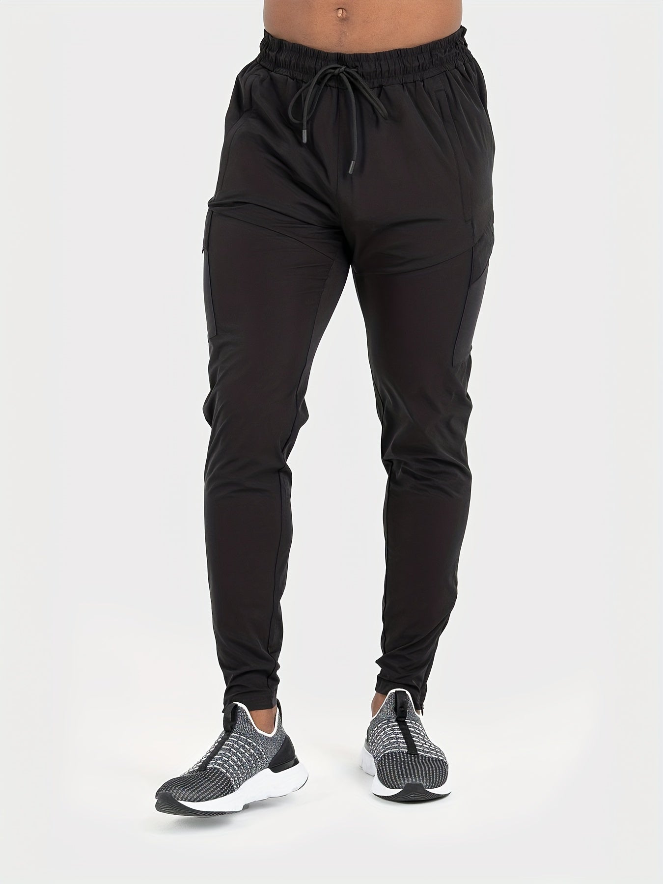 Men's athletic joggers, black - breathable, water-resistant, UV protection with side pockets for running, hiking, and outdoor activities.