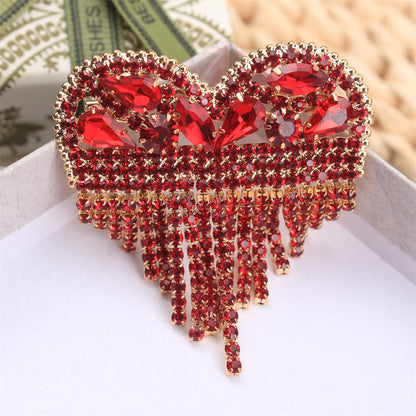 Luxurious Heart-Shaped Rhinestone Brooch Pin with Tassel, featuring an Elegant and Unique Irregular Shape. This Novelty Simulation Modeling accessory is perfect for ladies who want to make a fashion statement. Ideal for parties and also makes a great