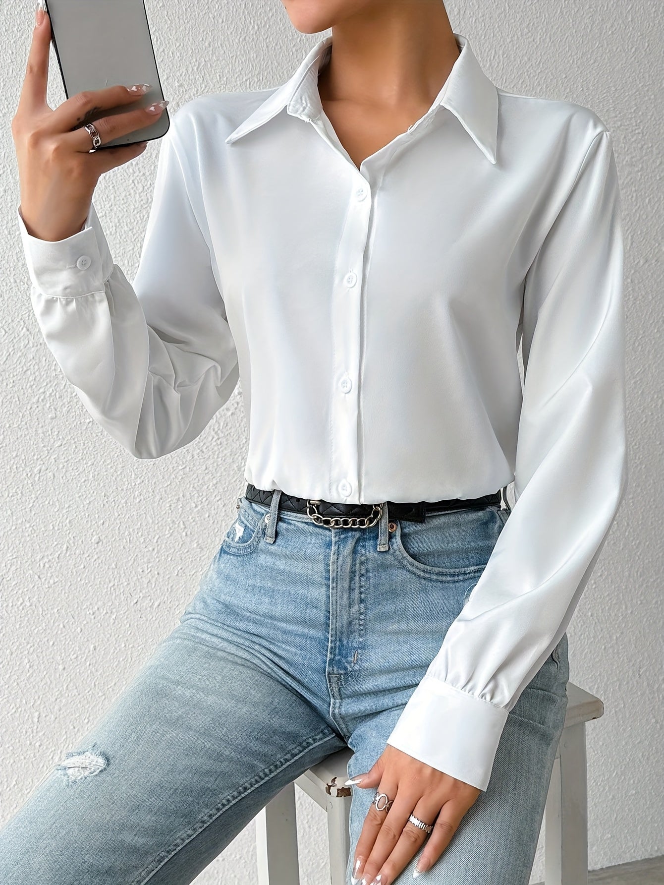 Elegant solid color collared bodysuit for women with button front and long sleeves.