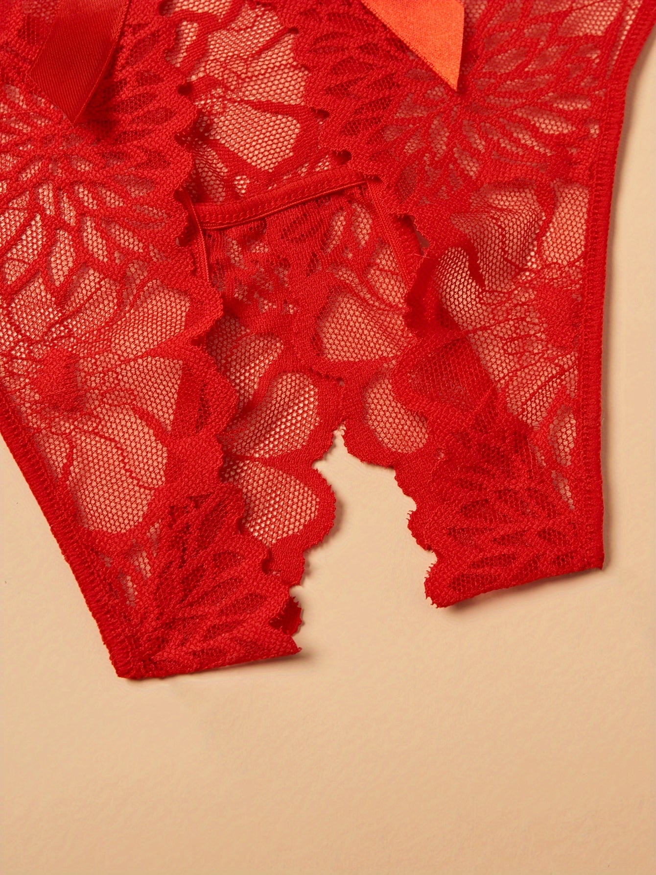 Plus size lace thong panties for women with back bow detail, made of nylon for a comfortable fit.