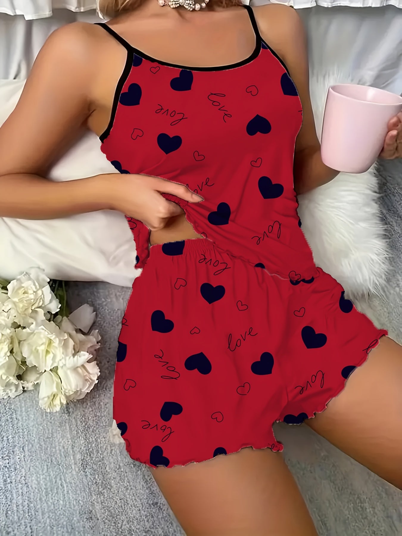 Stylish burgundy heart print pajama set with spaghetti strap top and shorts. Made from soft polyester blend, machine washable.