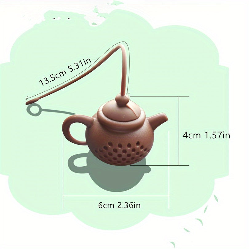 Reusable teapot-shaped tea infuser made of silicone for loose leaf tea, ideal for kitchen and dining use, small in size suitable for making tea.