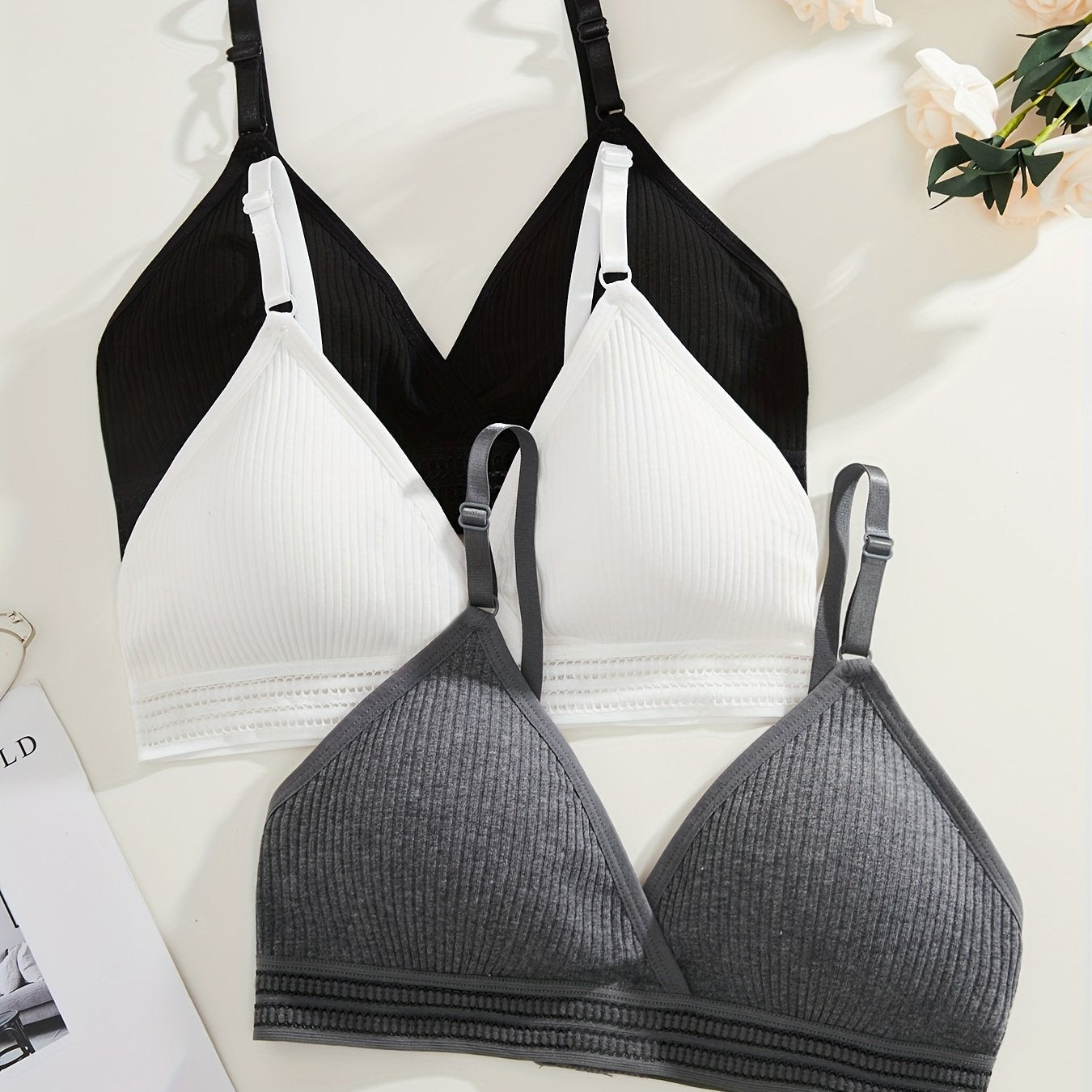 Soft, versatile bra set with removable pads and ribbed texture in black, white, and gray. Perfect for everyday comfort wear.