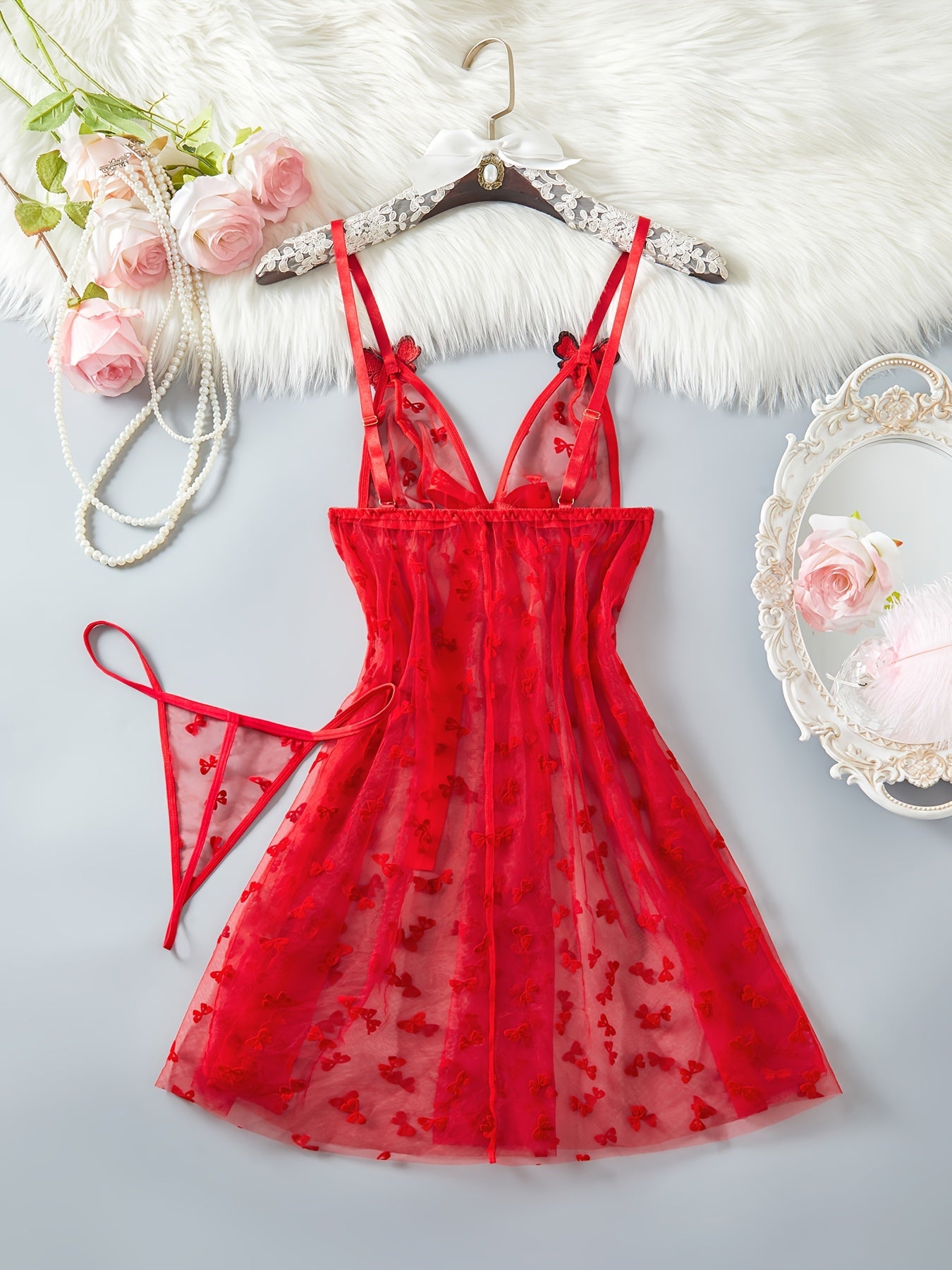 Elegant red mesh lingerie set for women with butterfly pattern babydoll and large bow detail. A sensual adult costume.