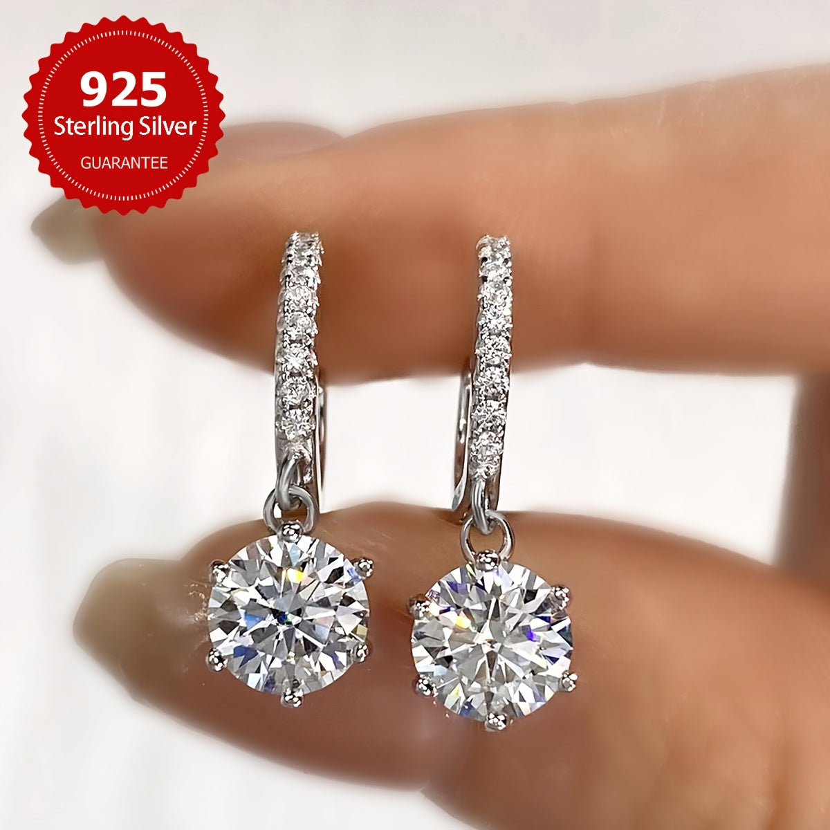 Sparkling 1CT Moissanite Earrings (1CT*2pcs=2CT, Silvery Weight Approximately 2.6g), perfect for weddings or Valentine's Day. Made of 925 Pure Silver with a six-claw design, these earrings exude a noble luxury. The ultimate gift for your loved one.