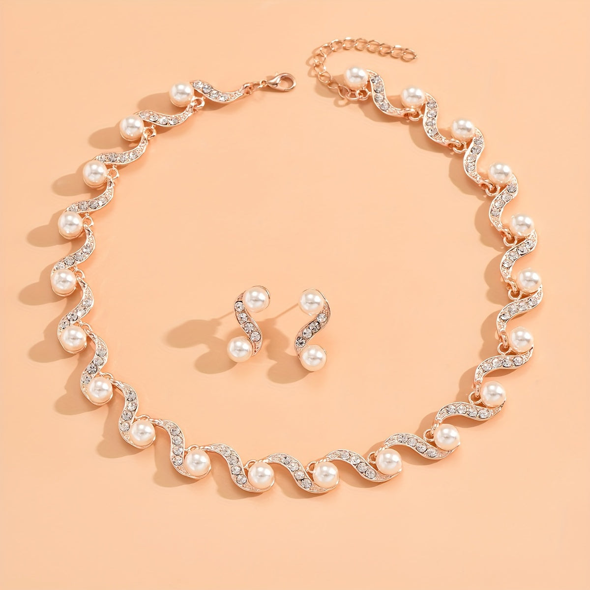 Stunning imitation pearl and diamond jewelry set, ideal for brides to wear on their special day.