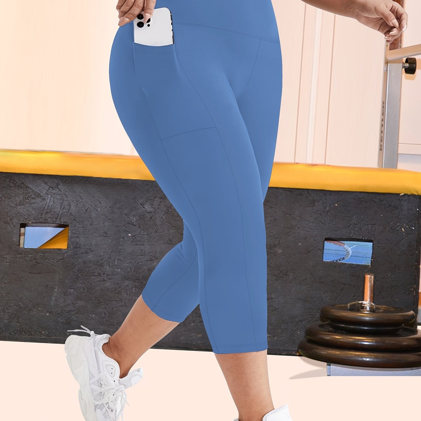 High-waisted capri leggings for plus-size women with side phone pockets, ideal for workouts.