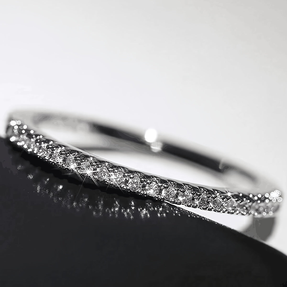 A stunning 925 Sterling Silver ring adorned with a sparkling line of zirconia. This high-quality engagement or wedding ring is the perfect gift for your beloved.