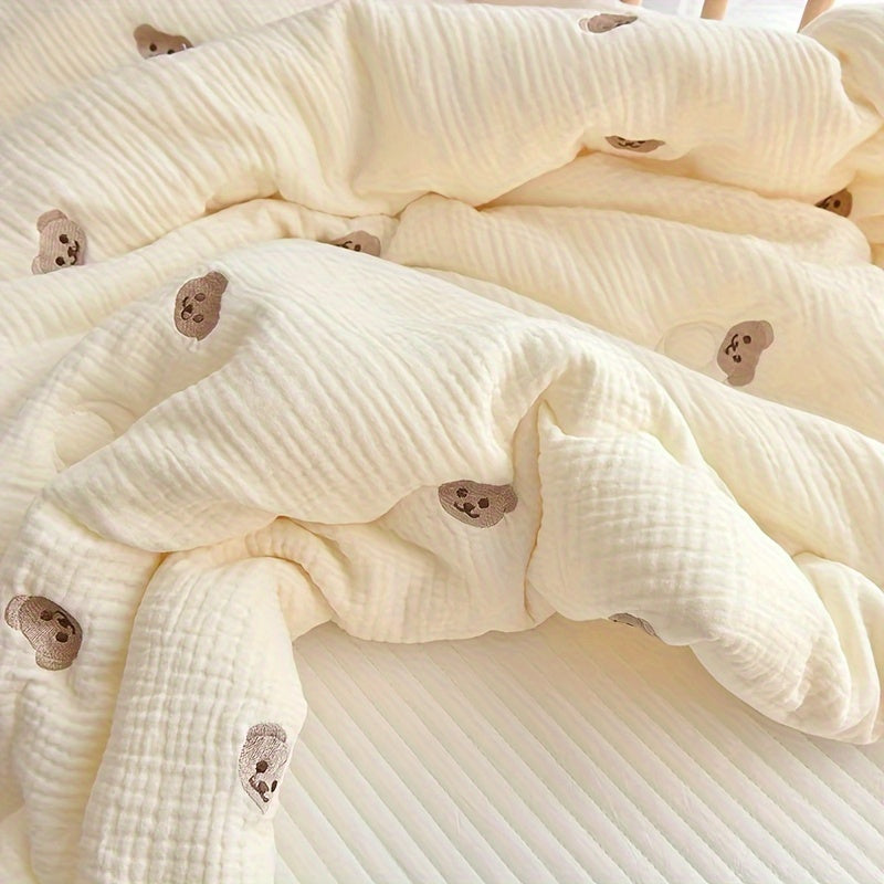 Soft cream-colored quilt with embroidered bear and rabbit, perfect for kids all year round. Made from durable knit fabric for naps and home use.