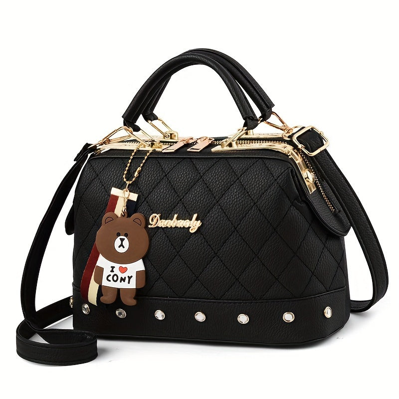 Stylish black shoulder bag for women with cute bear charm, detachable strap, zip closure, and quilted texture - ideal for travel and shopping.