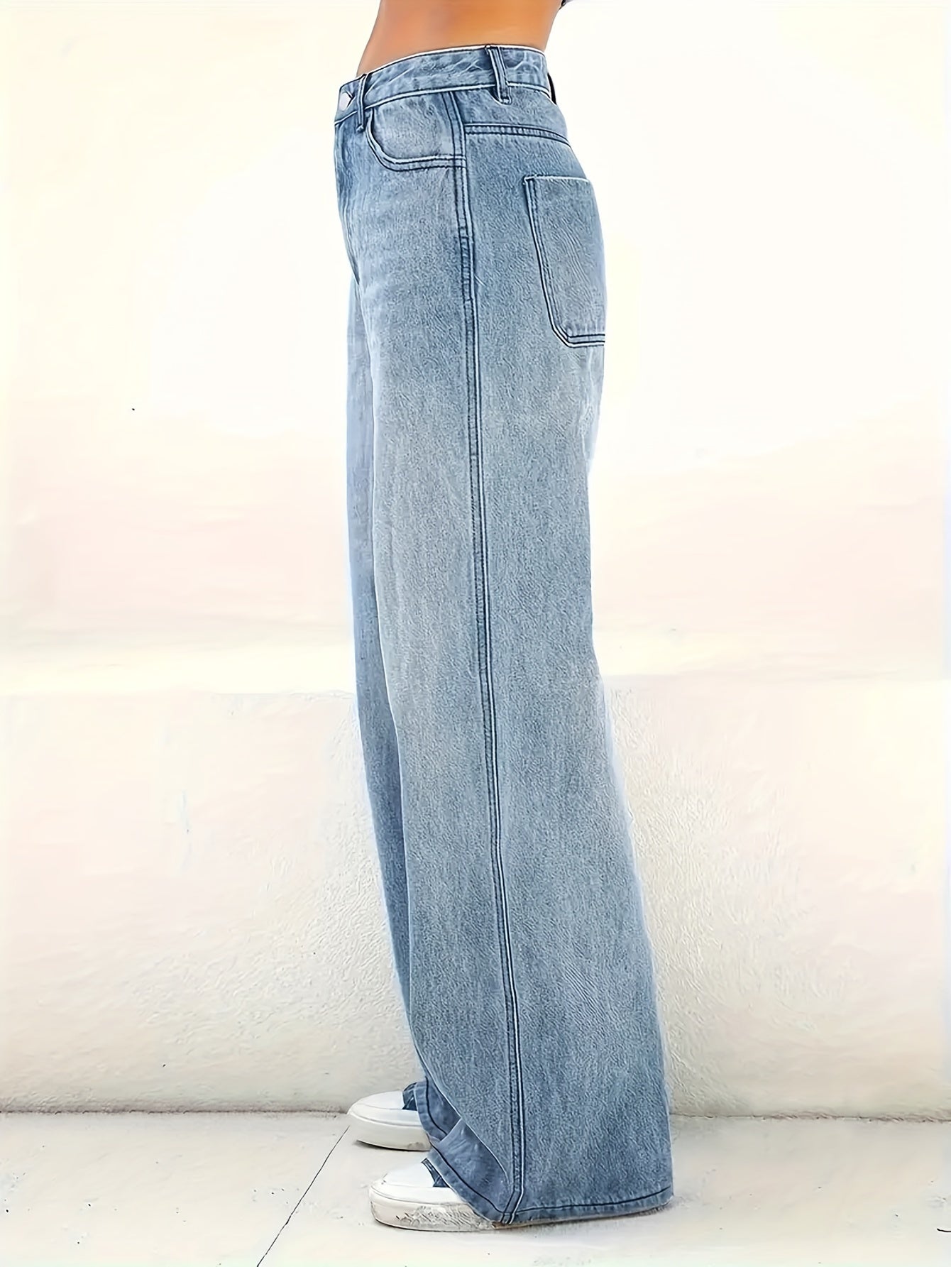 Women's wide leg jeans in plain washed blue denim, comfortable and classic design.