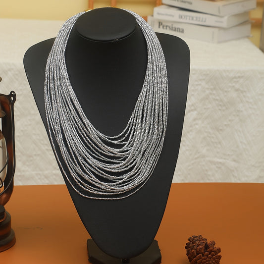 A trendy and flexible millet bead necklace with multiple layers.