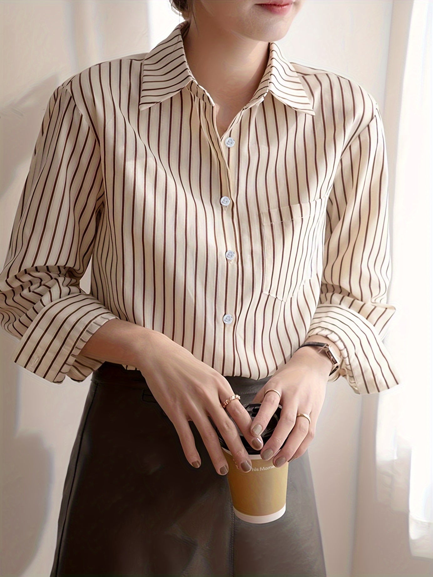 Beige striped blouse with button-up front, loose fit, machine washable.