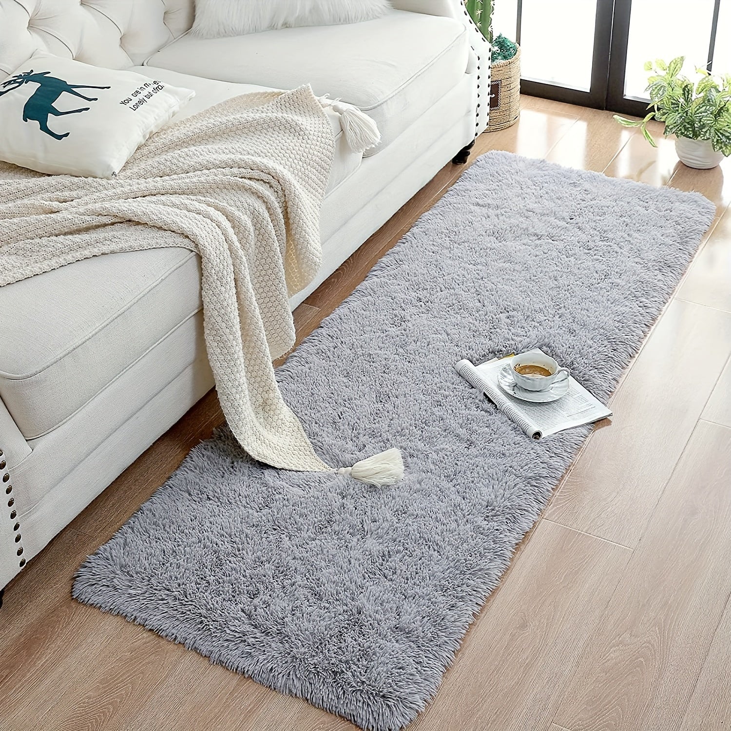 Soft and plush modern shaggy area rug, perfect for adding comfort and style to any indoor space. Made of polyester material, this decorative rug is ideal for living rooms, bedrooms, studies, and lounges. Dry clean only.