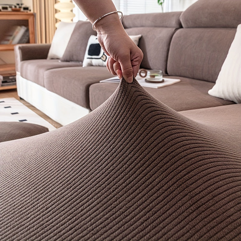 Stretchable polyester sofa cover with elastic band, pet-friendly polar fleece material, machine washable, fits armchair to sectional sofas, home decor slipcover for furniture.