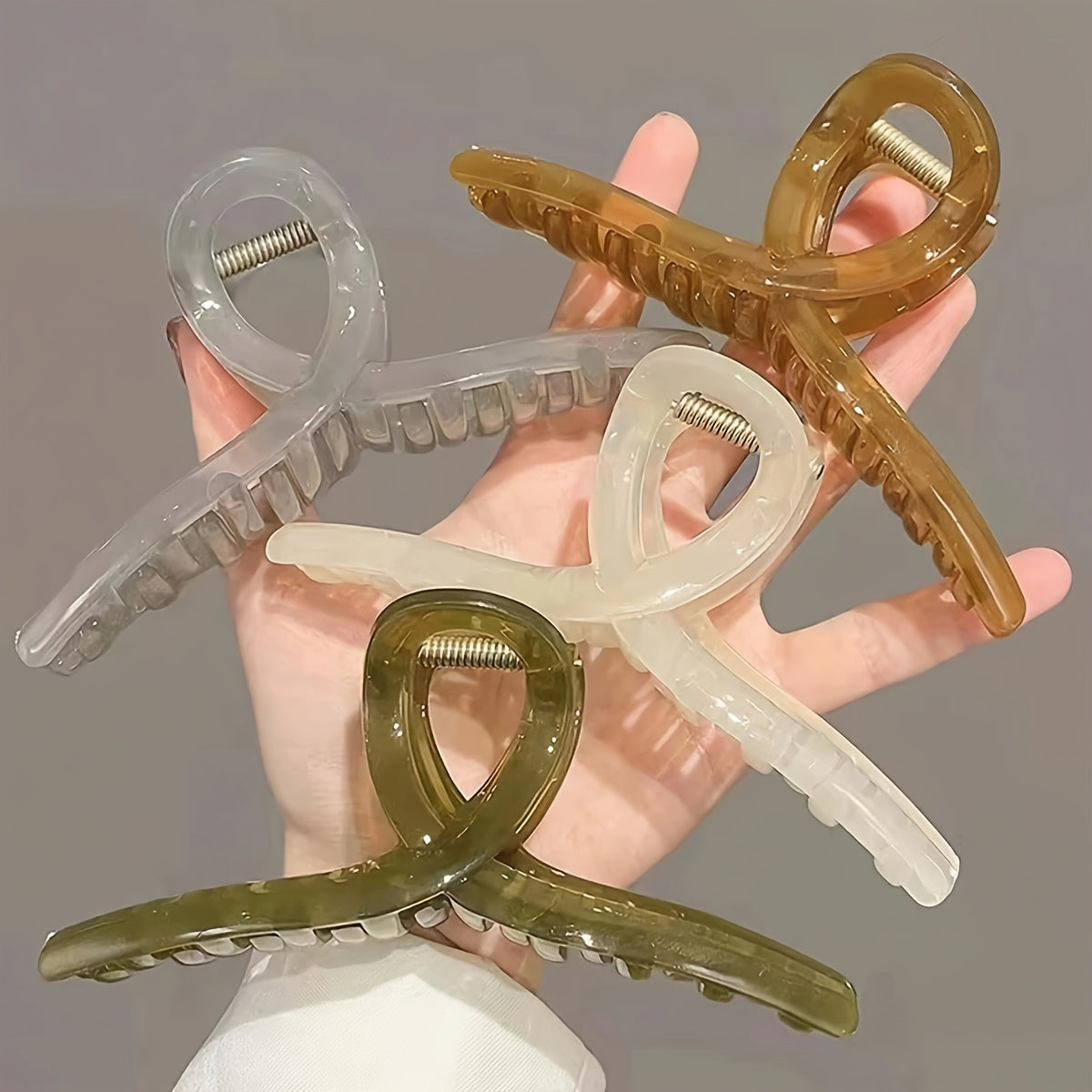 4 transparent grip clips with large shark clip design for back of head hair styling.