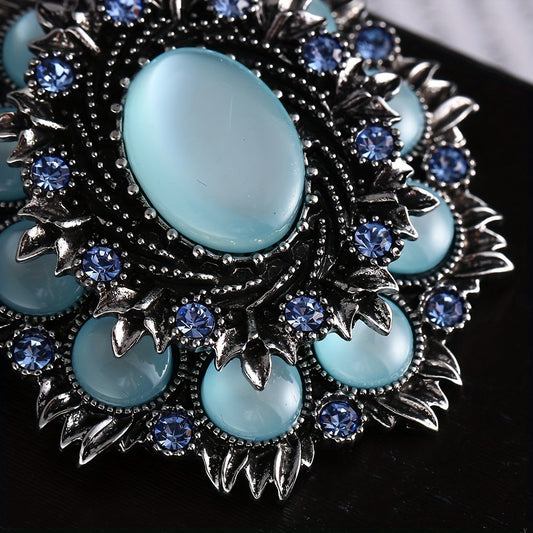 Sophisticated Vintage Flower-Shaped Brooch featuring Blue Cat Eye and Pearls, adorned with Rhinestones - a stylish accessory for both women and men.