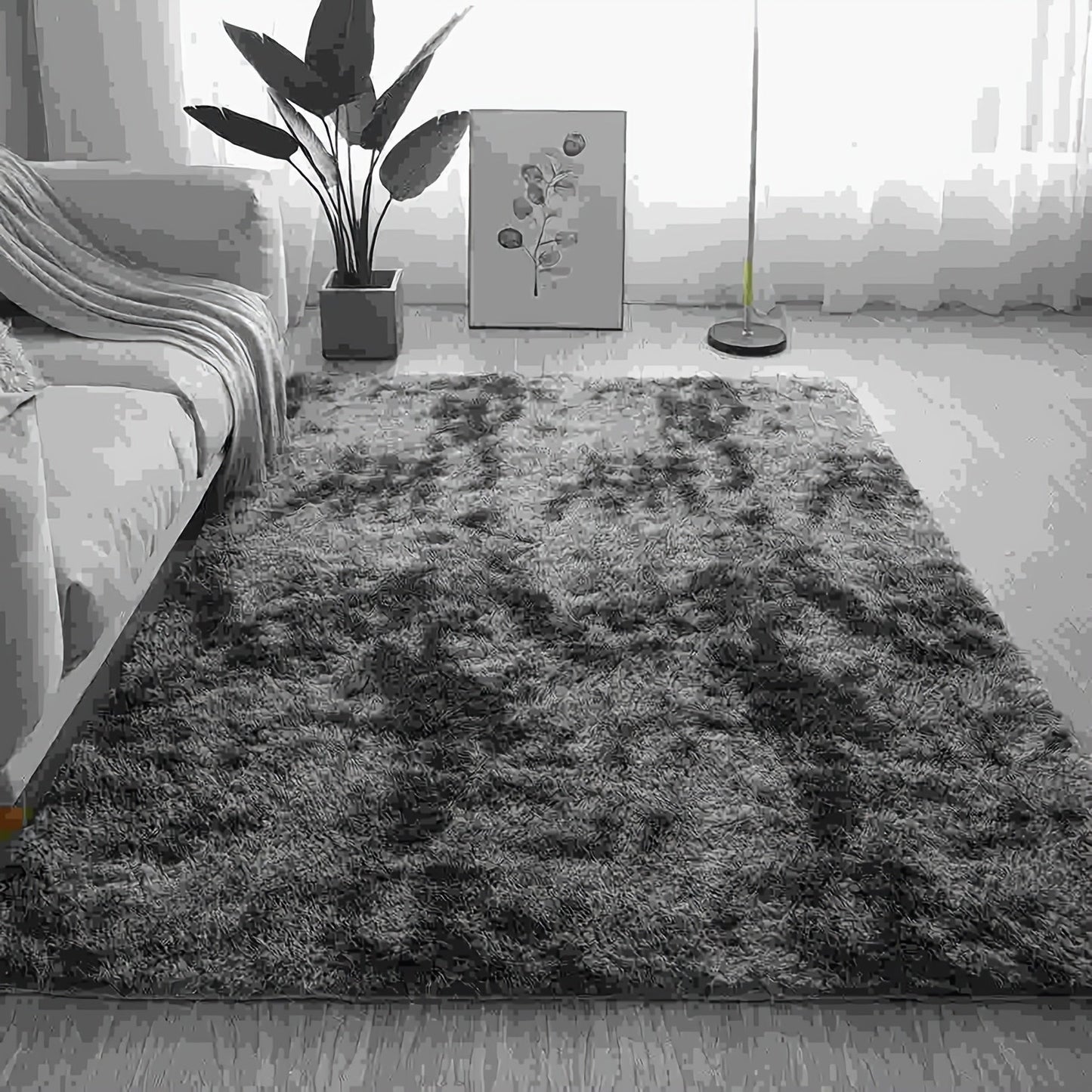 One piece of plush, fluffy area rug designed for bedrooms. This soft, fuzzy shaggy rug is black in color and rectangular in shape, perfect for adding warmth to your living room. It features a non-slip bottom to ensure safety. Great for Halloween or