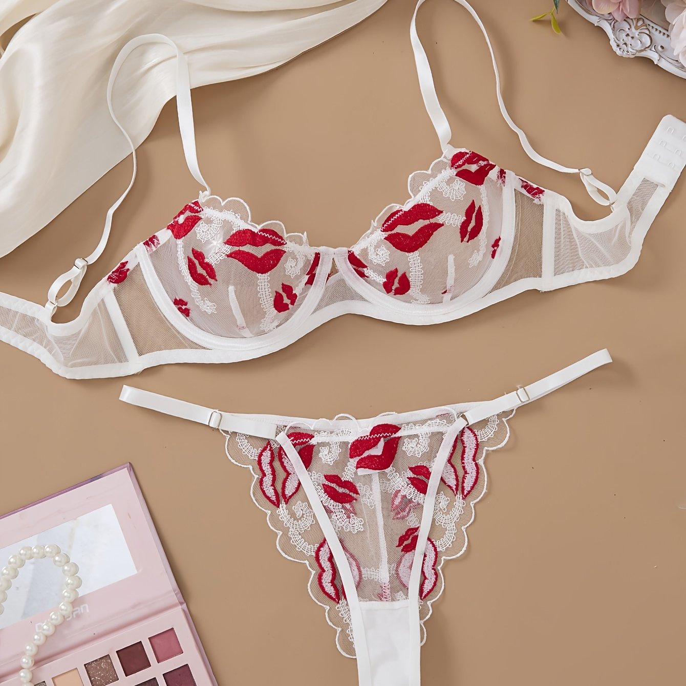 Valentine's Day lingerie set for women featuring embroidered sheer mesh bra and adjustable thong, made from mature style polyester knit fabric with medium support and no padding. Designed