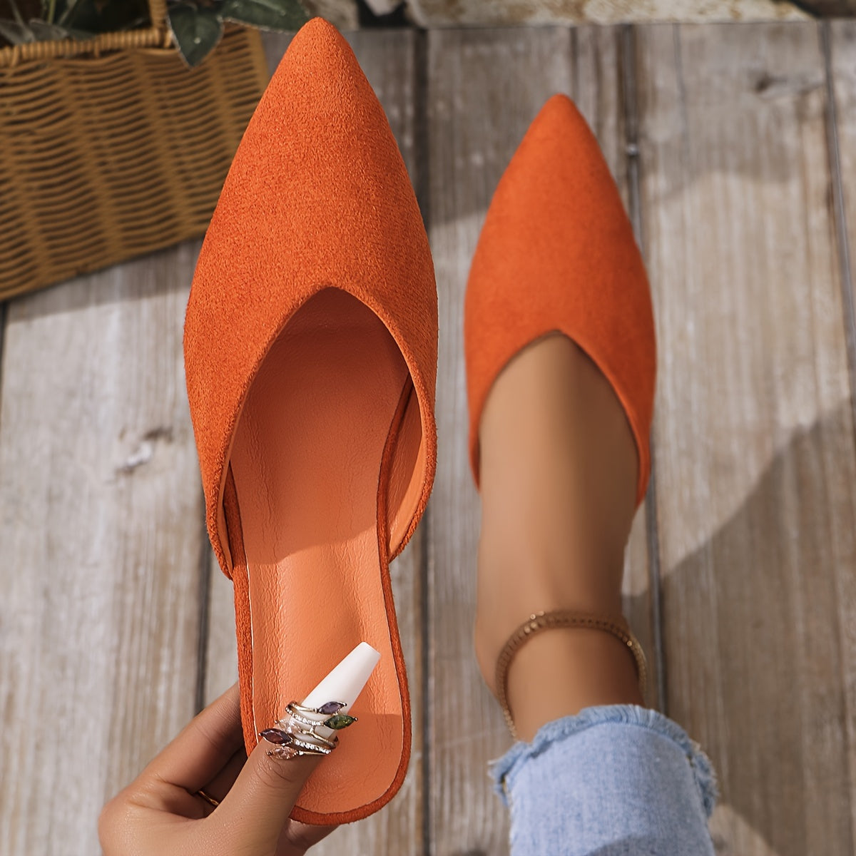 Stylish orange flat mules for women in plus sizes with pointed toe and slip-on design, perfect for casual wear.