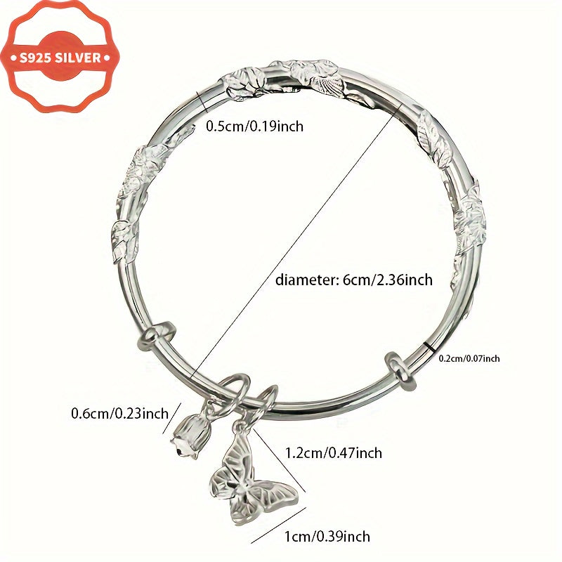 Add a touch of boho luxury to your wardrobe with this stunning 925 silver bangle bracelet featuring 18K golden plated charms. Handcrafted with floral designs, butterfly, and bell pendants, this hypoallergenic cuff is perfect for women who love unique