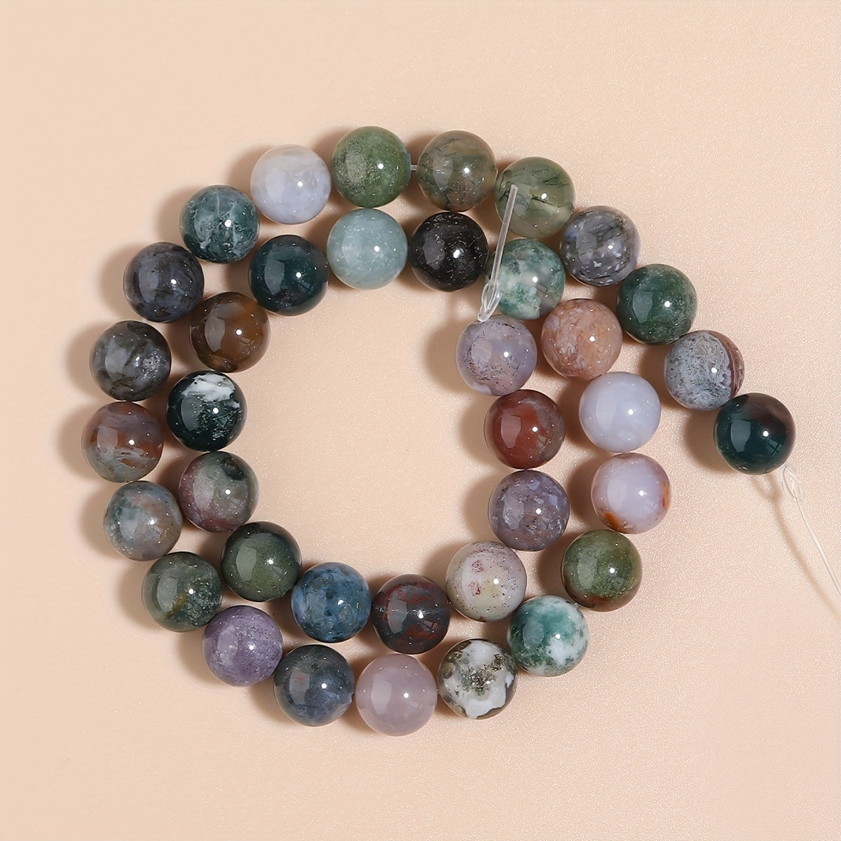 Indian Agate Round Loose Spacer Beads available in natural stone, perfect for DIY bracelet making. Each strand measures 15 inches in length with bead sizes of 4, 6, 8, 10, and 12mm. Ideal for creating unique jewelry accessories.