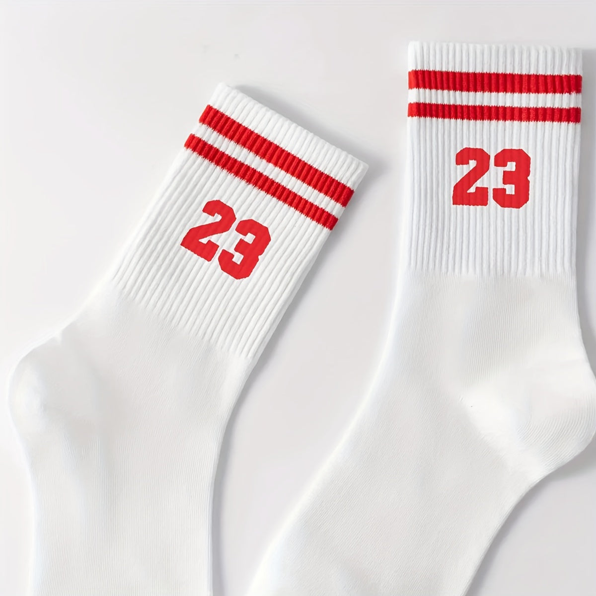 Men's athletic mid-calf socks with striped pattern featuring number 23. Made of 95% polyester and 5% spandex. Hand wash only.