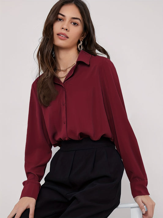 Stylish maroon button-up blouse for women, with long sleeves, curved hem, and made of machine-washable polyester blend. Perfect for work or casual wear.