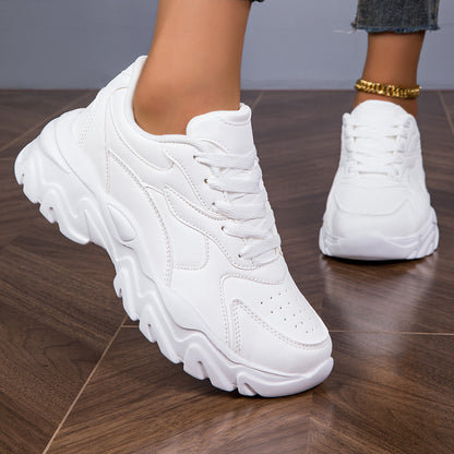 Women's white low-top lace-up sneakers for casual walks and shopping.