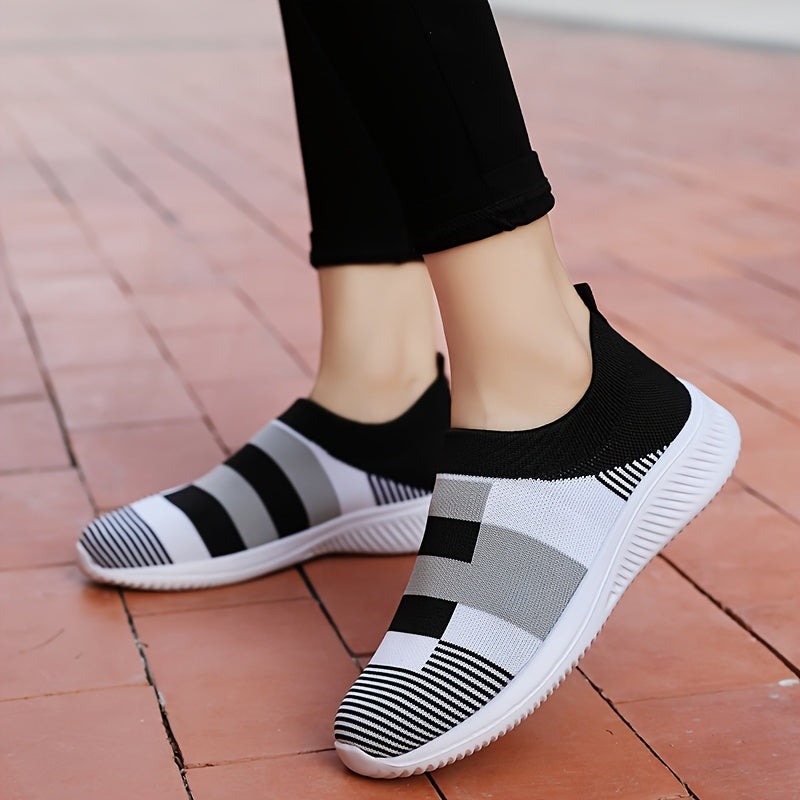 Breathable mesh slip-on sneakers for plus size women in pink, gray, and white plaid with soft sole and round toe design, suitable for all seasons.