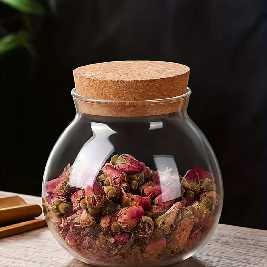 This glass storage jar with cork lid holds 16.9oz and is perfect for storing various items in your kitchen. Made of BPA-free and heat-resistant materials, it is a versatile canister that can be used for storing coffee beans, tea, flour, sugar, and more.