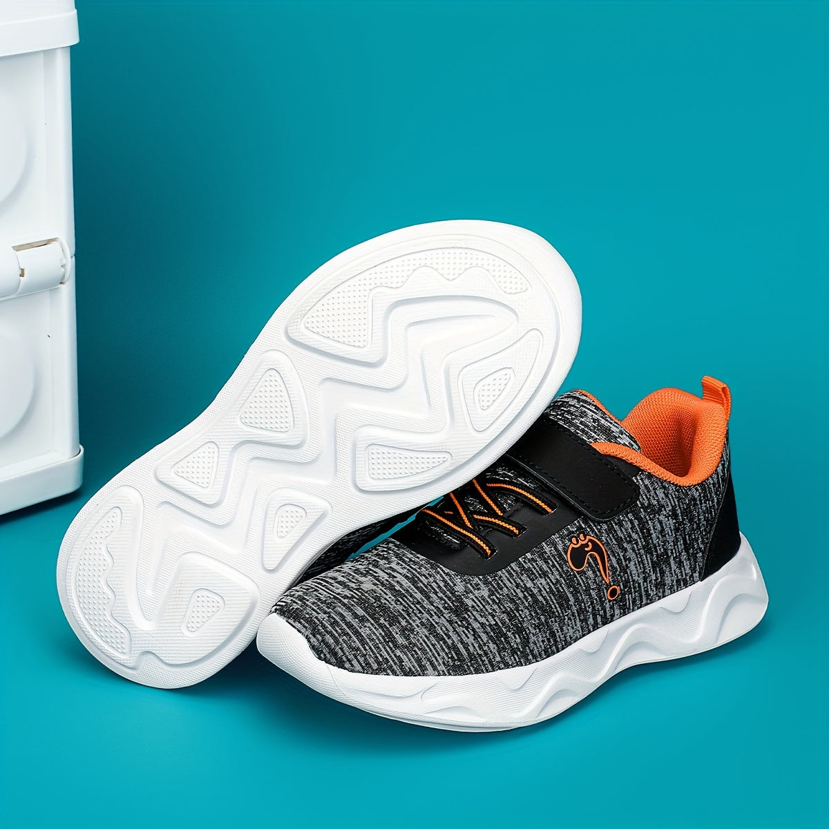 Breathable sneakers for kids with non-slip soles and hook and loop closure.