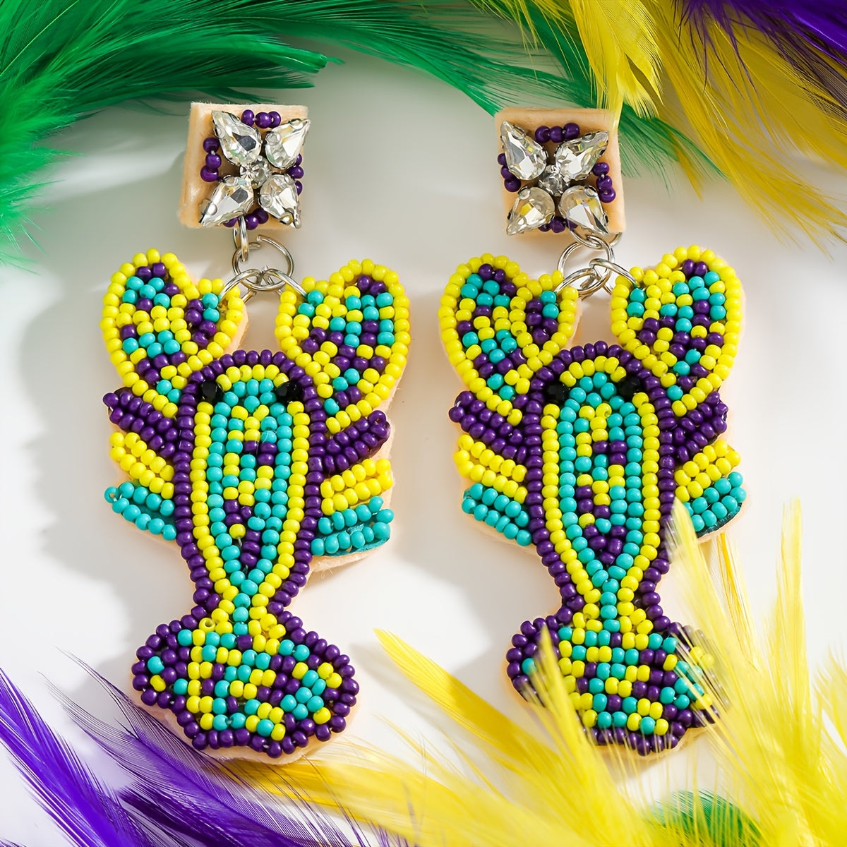 Mermaid-inspired beaded earrings with a Boho twist, adorned with colorful beads and rhinestones. Featuring a lobster claw design and stainless steel posts, these festive Mardi Gras earrings are perfect for daily wear or party occasions year-round.