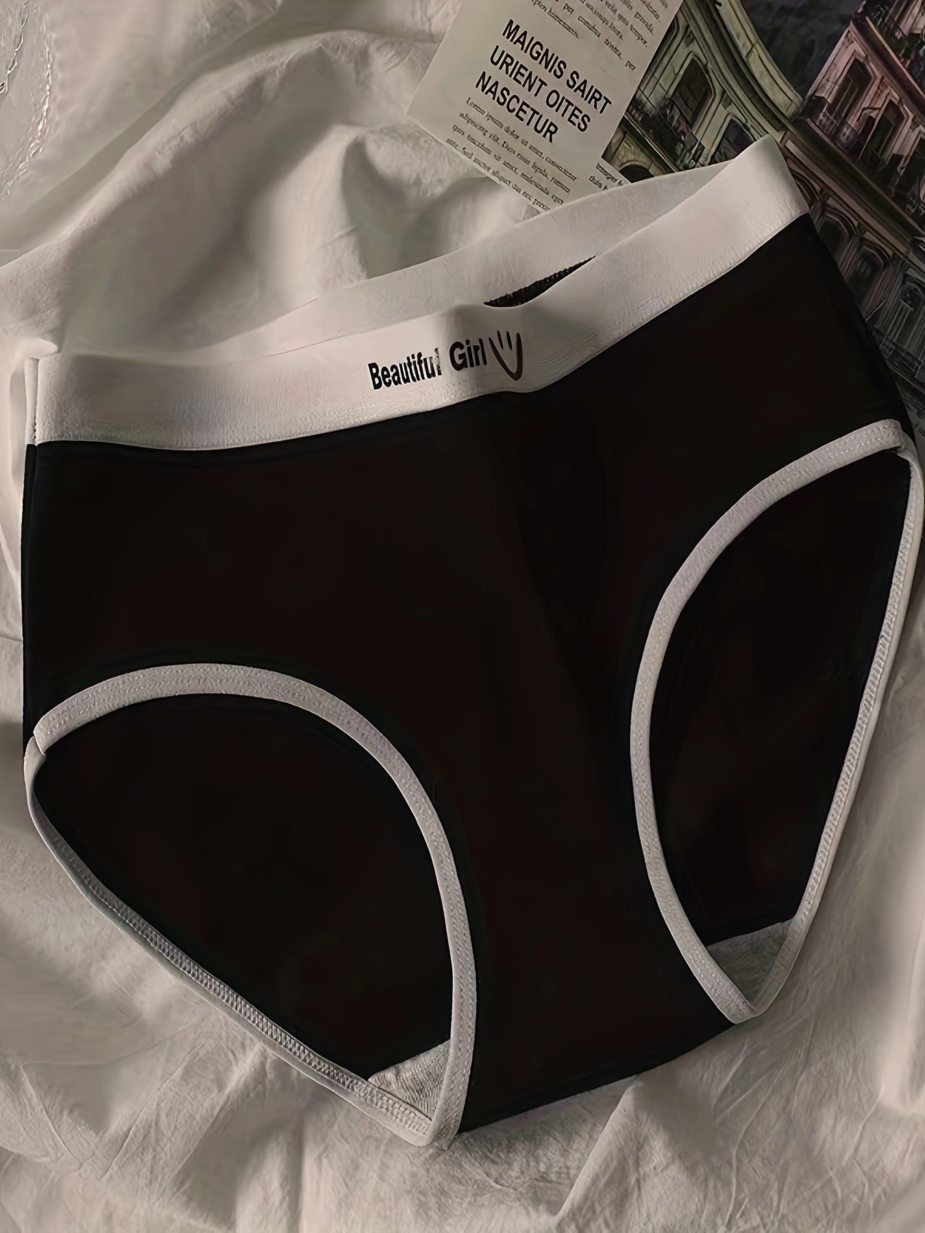 Women's period panties made with seamless, breathable fabric in black and white with joyful face design, perfect for casual wear and cute style.