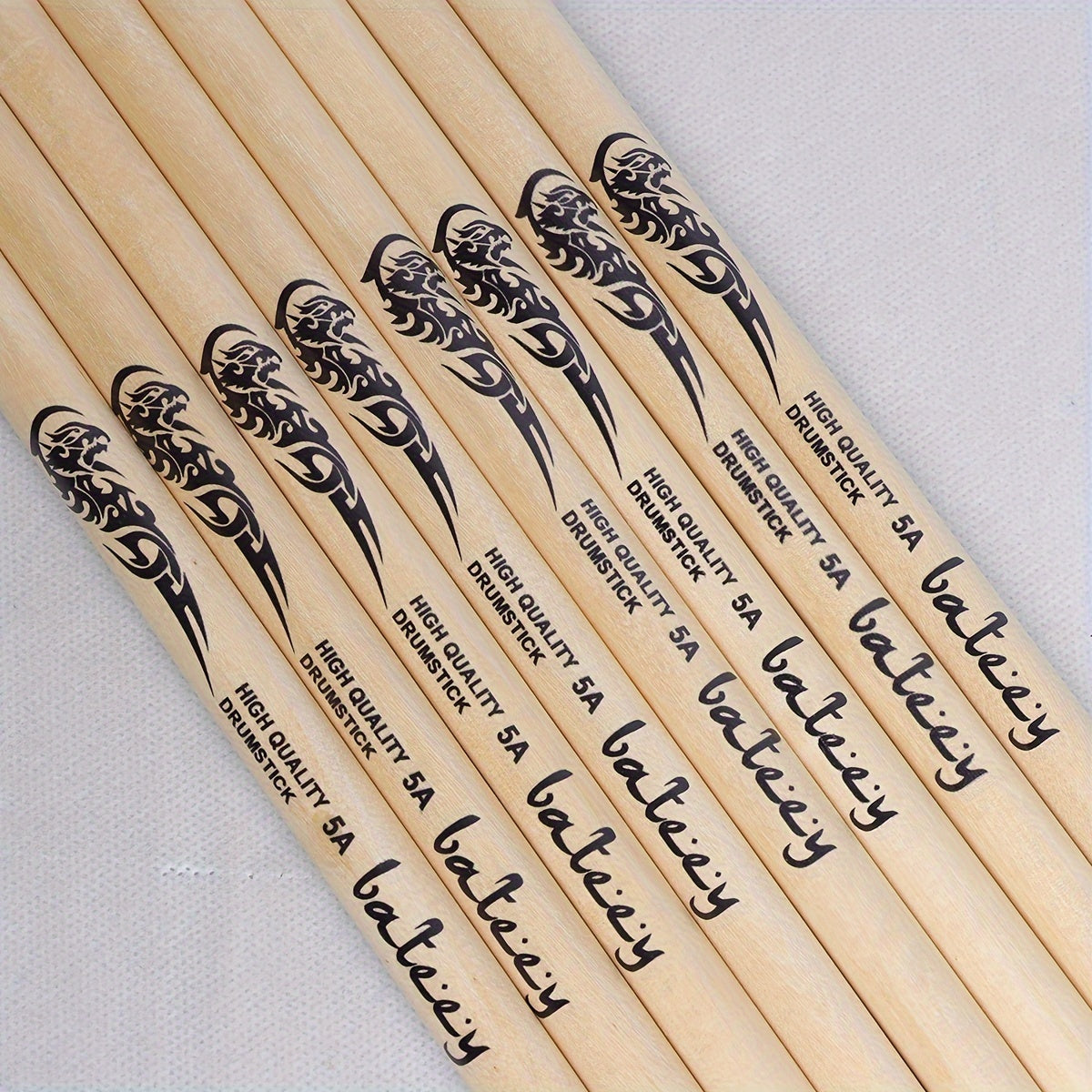 Lightweight drumsticks with totem design, selectable sizes 5A, 7A, and 5B. Made of high-quality natural wood with a precision grip, uncharged pair.