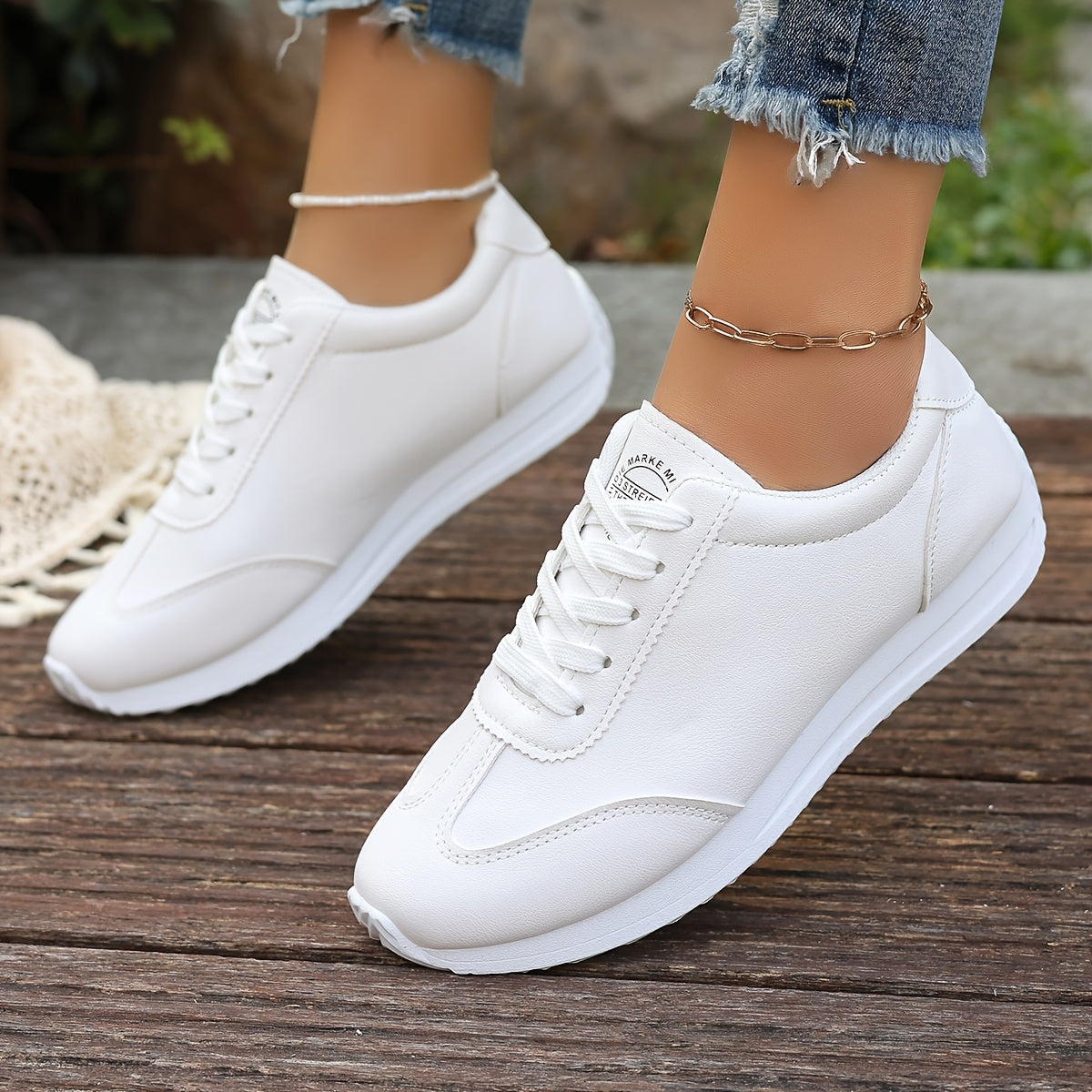 White synthetic leather women's casual sneakers with stability support, all-season comfort, and breathable fabric lining. Perfect for casual attire.