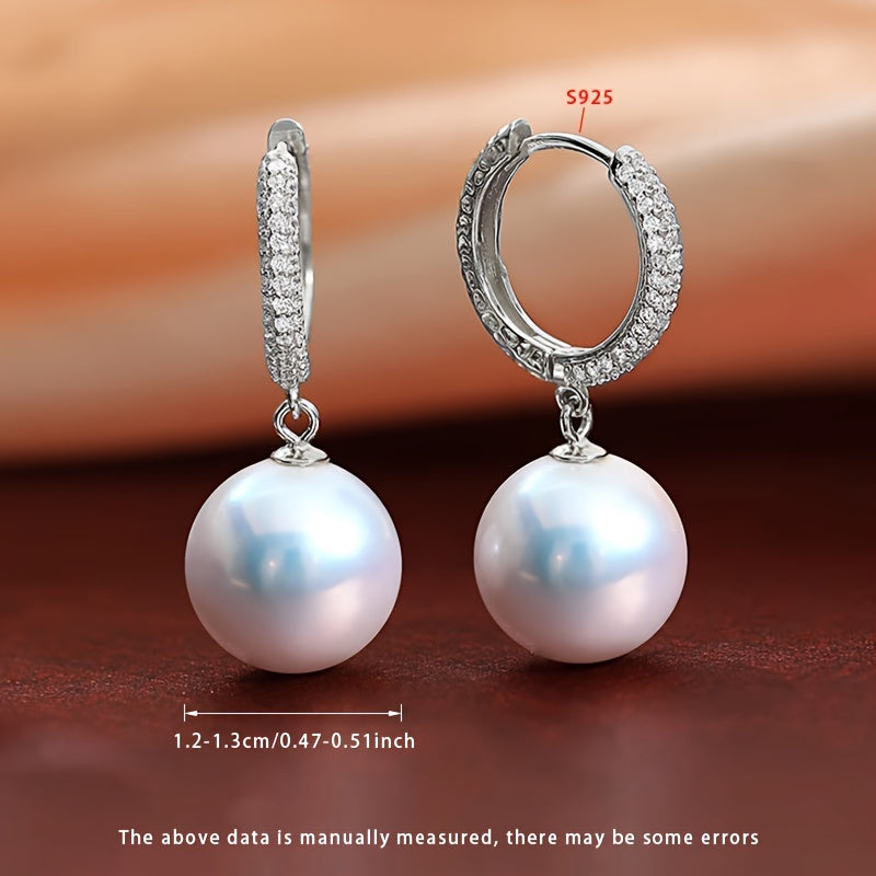 Get ready to dazzle with the luxurious elegance of these Daimi Hoop Earrings, made with 925 Sterling Silver and adorned with a natural Freshwater Pearl, the perfect June Birthstone gift for any occasion